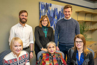 Researchers pose for a photo after they create curriculum for helping people deal with trauma.