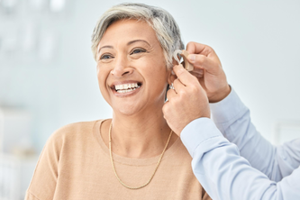 Woman in her 60s wearing a hearing aid