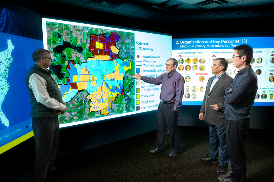 Researchers standing in front of an interactive map