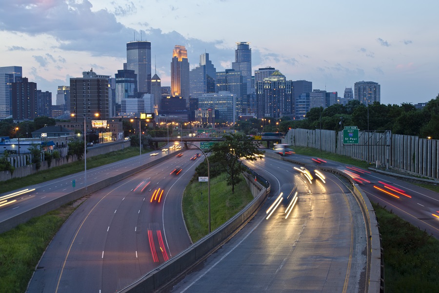 Image of the Minneapolis, Minnesota skyline overlooking a highway with cars driving across it.