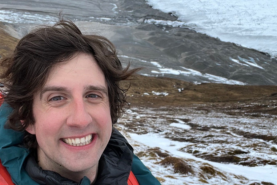 Christopher Hansen, dark hair, smiling, with glacial landscape.