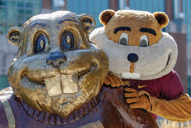 Golding posing with a statue of Goldy