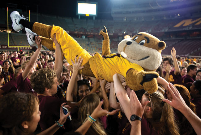 Goldy crowd-surfing on football field