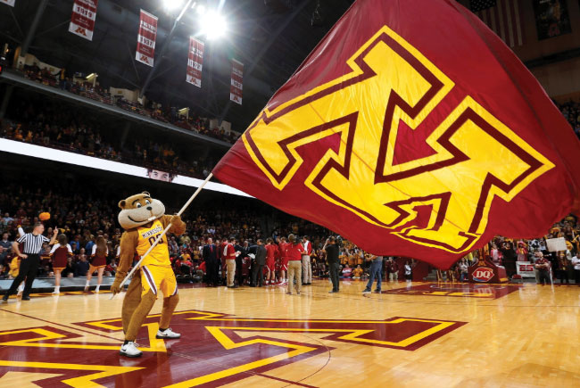 Goldy waving giant U of M flag at basketball game
