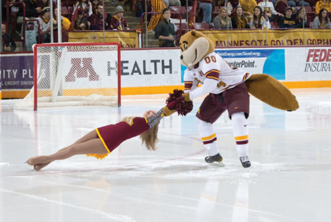 Goldy pair ice dancing with Gopher cheerleader at hockey game