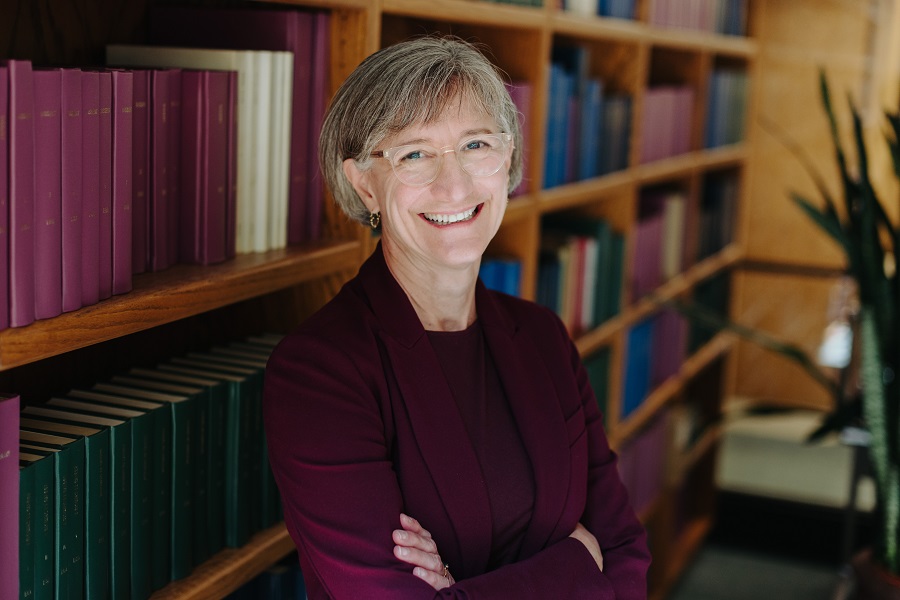 Portrait of Chancellor Janet Schunk Ericksen in front of a bookshelf.