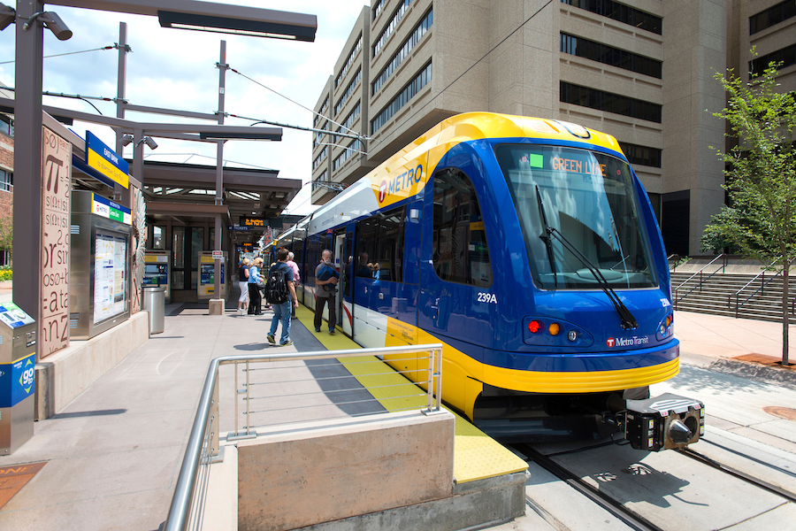 Photo of the Metro Transit East Bank station with students boarding the light rail.