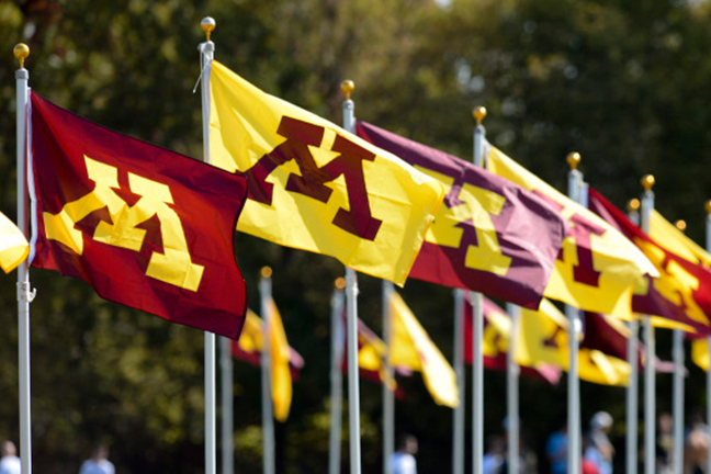 Maroon and gold M flags waving in the wind.