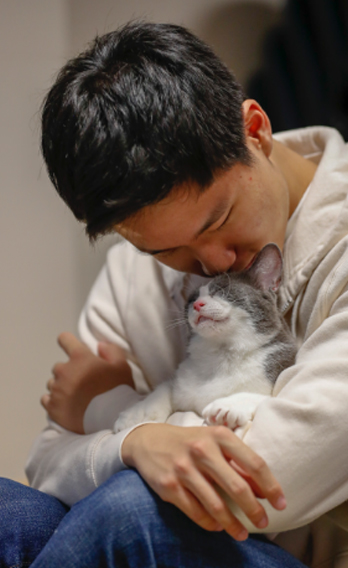 a student holding a cat