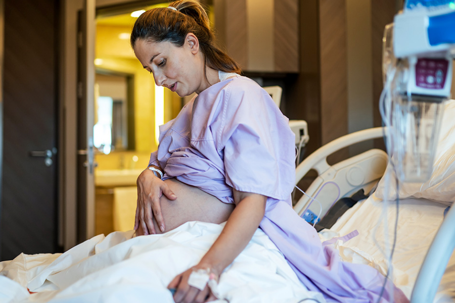 Pregnant mother in a hospital bed