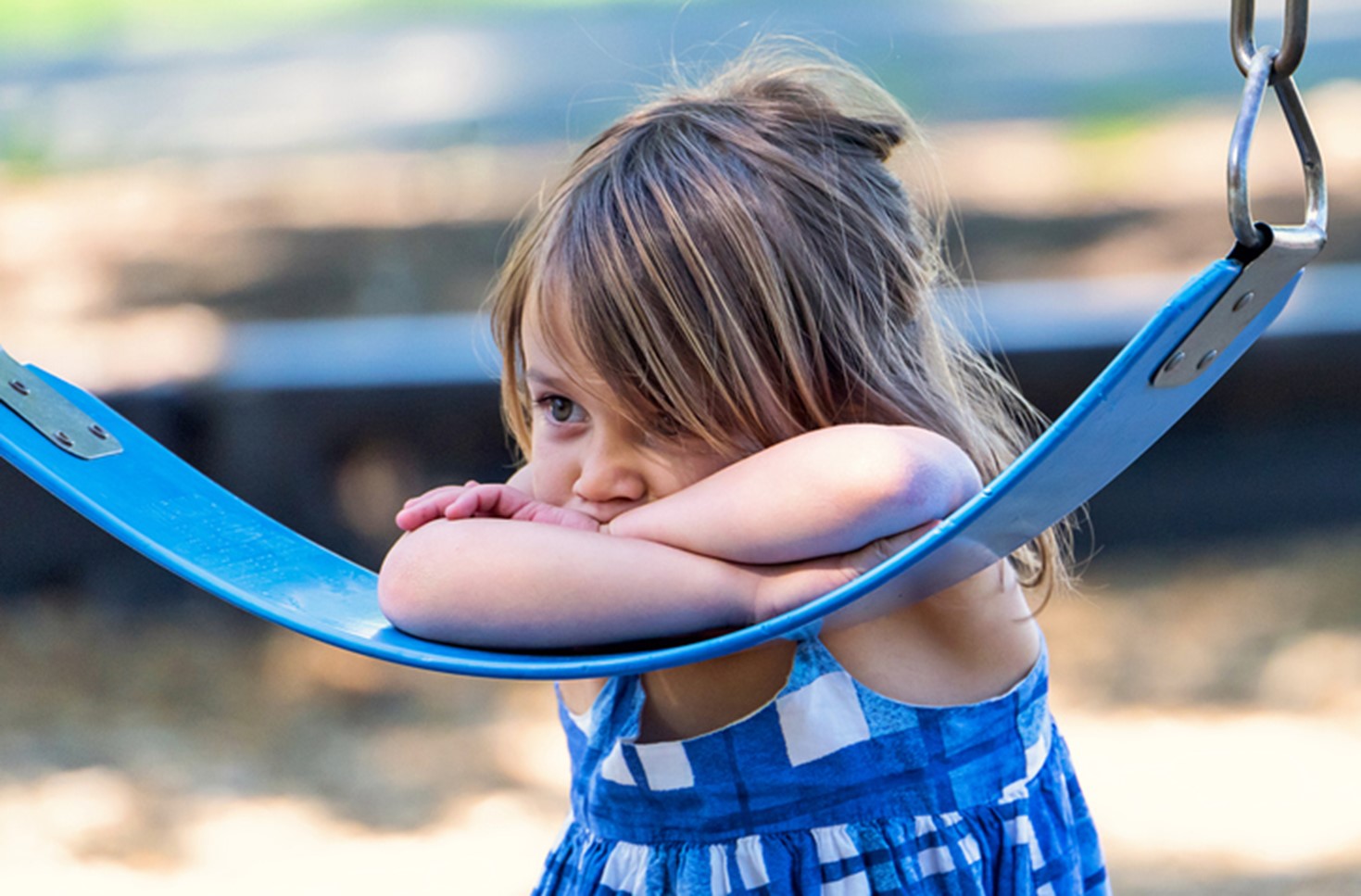 Image of young girl on a swing set.