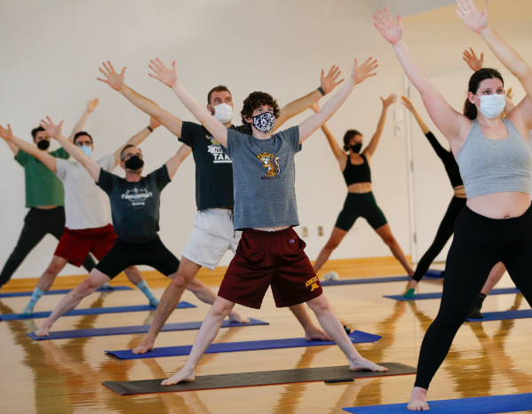 students stretching on yoga mats at a recreation and wellness center