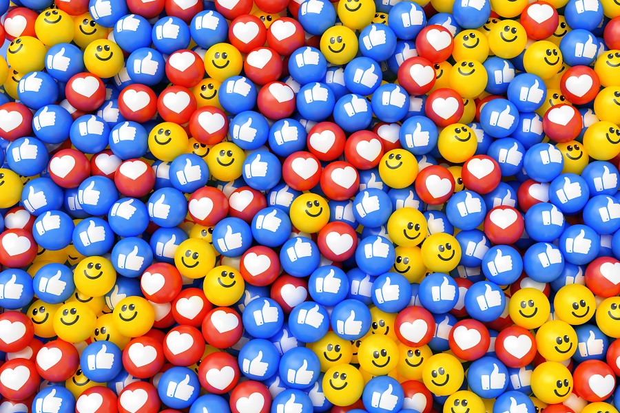 A pit of balls with emoticons on them: smiley faces, hearts and like buttons.