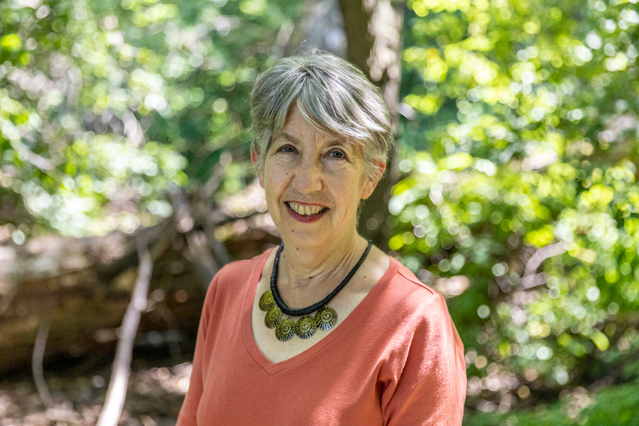 Biologist Marlene Zuk in a sunny wooded area