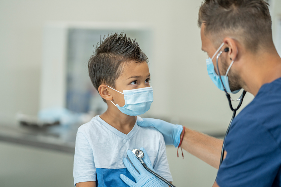 Provider taking a pulse of a child patient