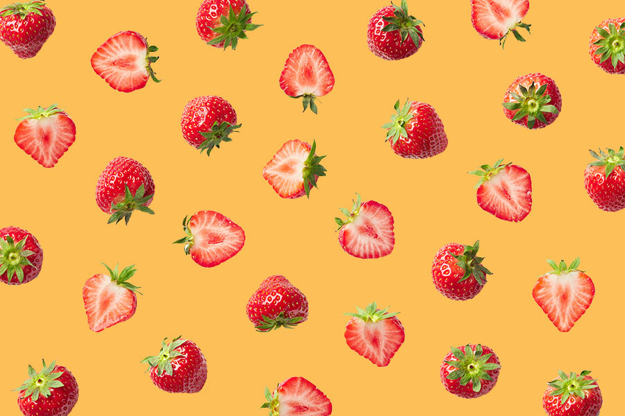An image of a bunch of equally spaced strawberries agains a gold backdrop