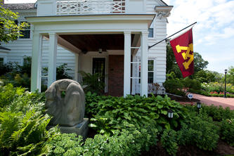 Entrance to the Eastcliff residence with a U of M flag outside