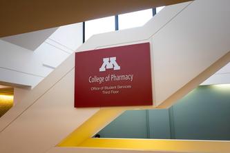 Image of a sign that has the logo for the University of Minnesota College of Pharmacy.