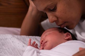 Photo of a Black mother and newborn baby