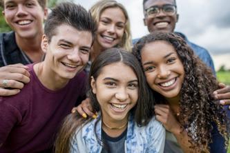 Image of teenagers smiling at camera.