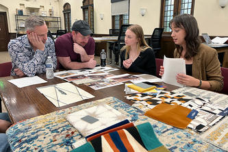 Interior design students Anneka Salstrom and Catja Peterson present their designs to the Pillsbury Castle owners Matthew Trettel and Ryan Hanson. Photo courtesy of Anne Farniok.