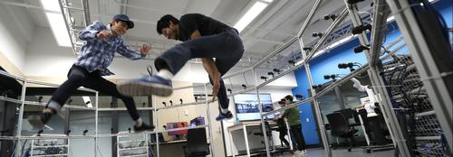 Researchers jumping in a robotics lab