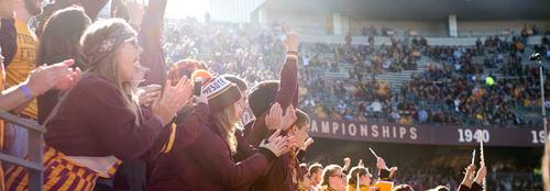 Students cheering in the student section during Gopher football game