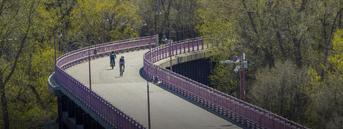 cyclists crossing the commuter bridge over the Mississippi river