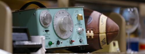 detail of objects in the reuse center: an old machine that looks like a radio and a football
