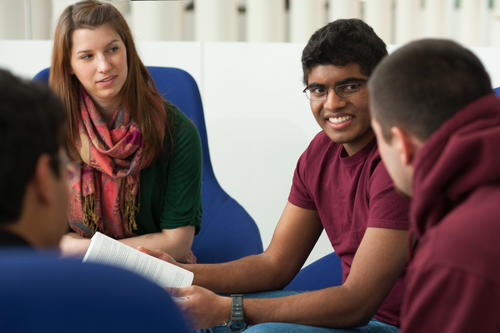 A group of students sit in a lounge talking
