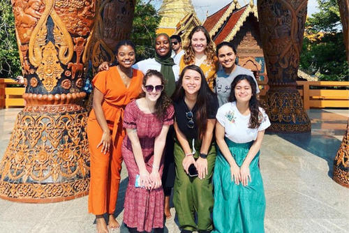 group of students posing in front of shrine
