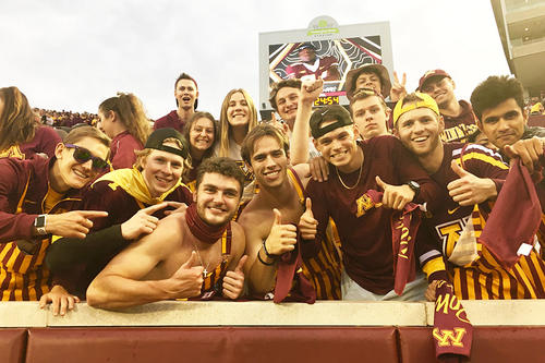 Gopher fans in the student section pose before the football game against Ohio State. 