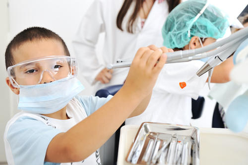 Child with PPE in dentist office
