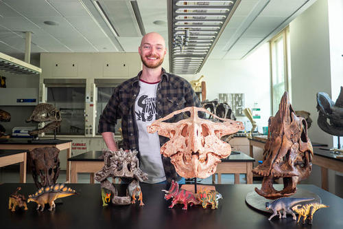 Viktor Radermacher with reconstructed dinosaur skulls.