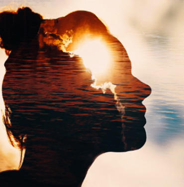 Silhouette of a girl head over sunset