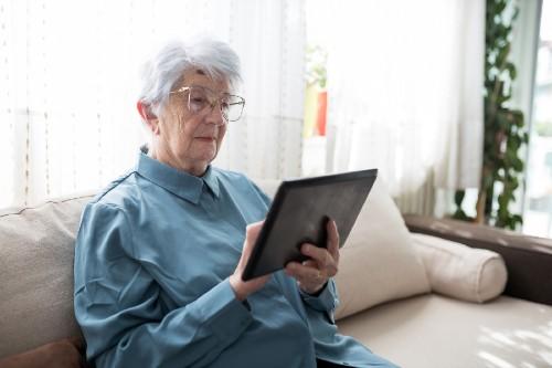 Woman on couch holding an iPad