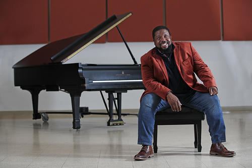 Adrian Davis with grand piano in background