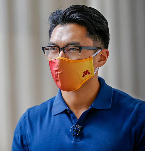 Asian male wearing glasses and UMN facemask