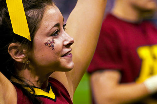 A close-up of a University of Minnesota cheerleader in action.