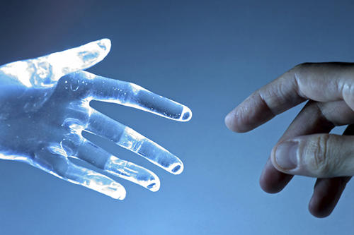 A human hand connects with a robotic one.