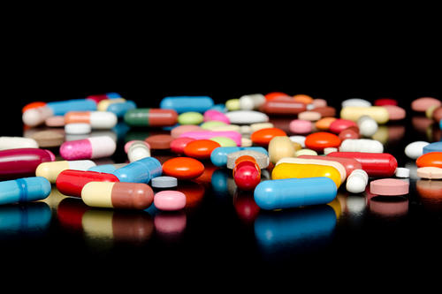A shot of pills of many colors.