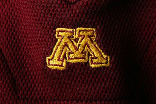 An &#039;M&#039; on maroon fabric