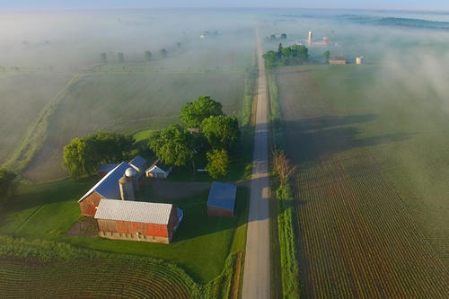 An aerial view of a farm on a glorious foggy day