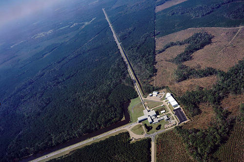 An aerial view of the LIGO site in Louisiana, showing 2.5-mile-long extensions of the experiment against the verdant countryside. 