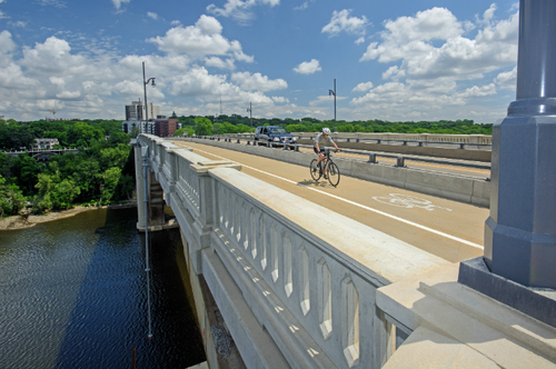 Biker crossing bridge 