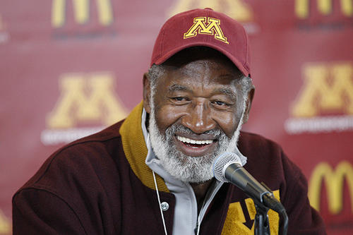 Bobby Bell sits in front of a microphone.