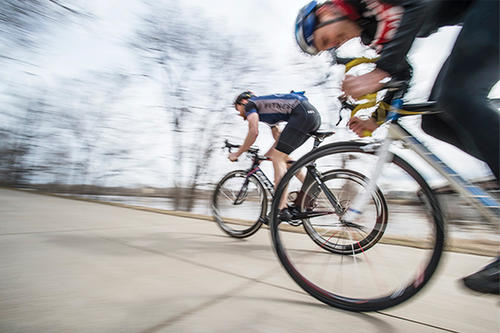 Cyclists race by in a blur.