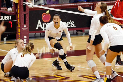 Gopher volleyball players celebrate in a match against Ohio State.