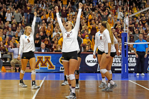 Gopher volleyball players celebrate in a match against UCLA.