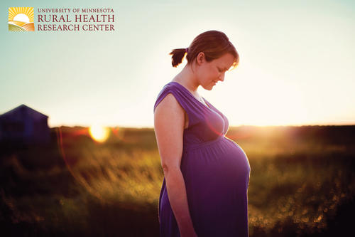 Pregnant woman standing in field.